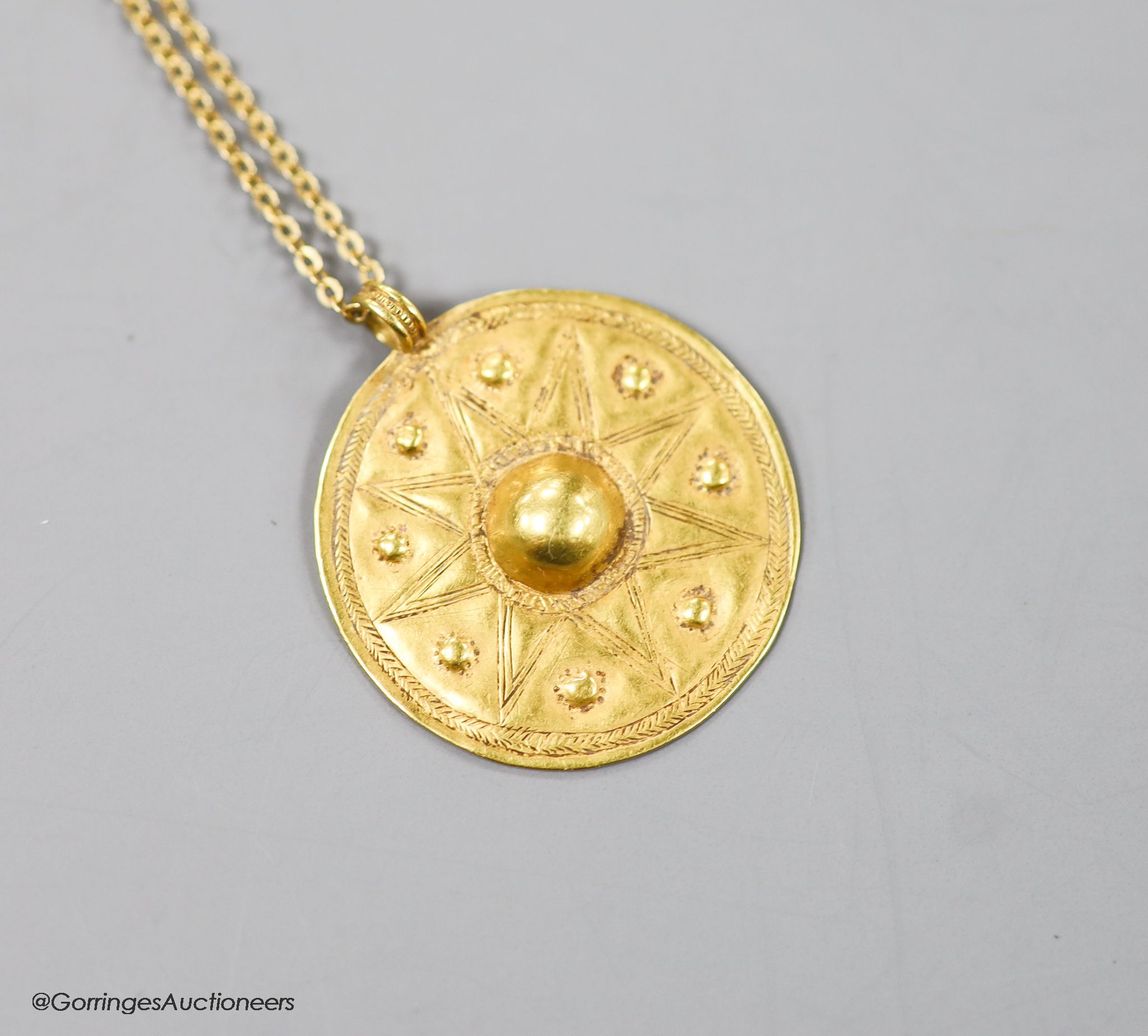 A modern Italian 18ct chain with a circular yellow metal possibly Roman pendant, 30mm, gross weight 7.8 grams